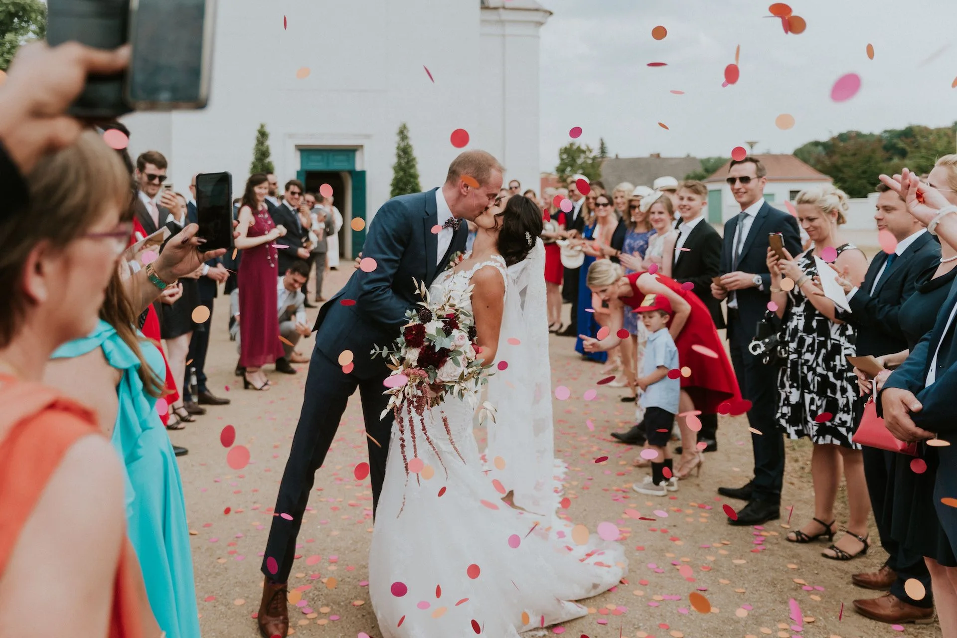 Wedding kiss with confetti at Schloss Neuhardenberg
