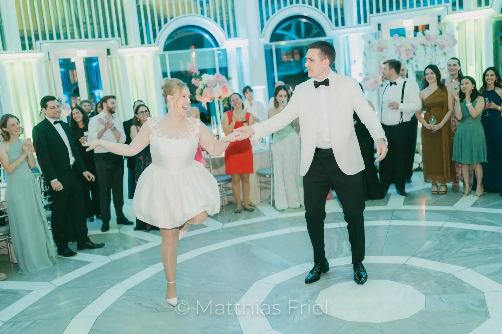 Sylvie in her evening dress dancing with Max at the party