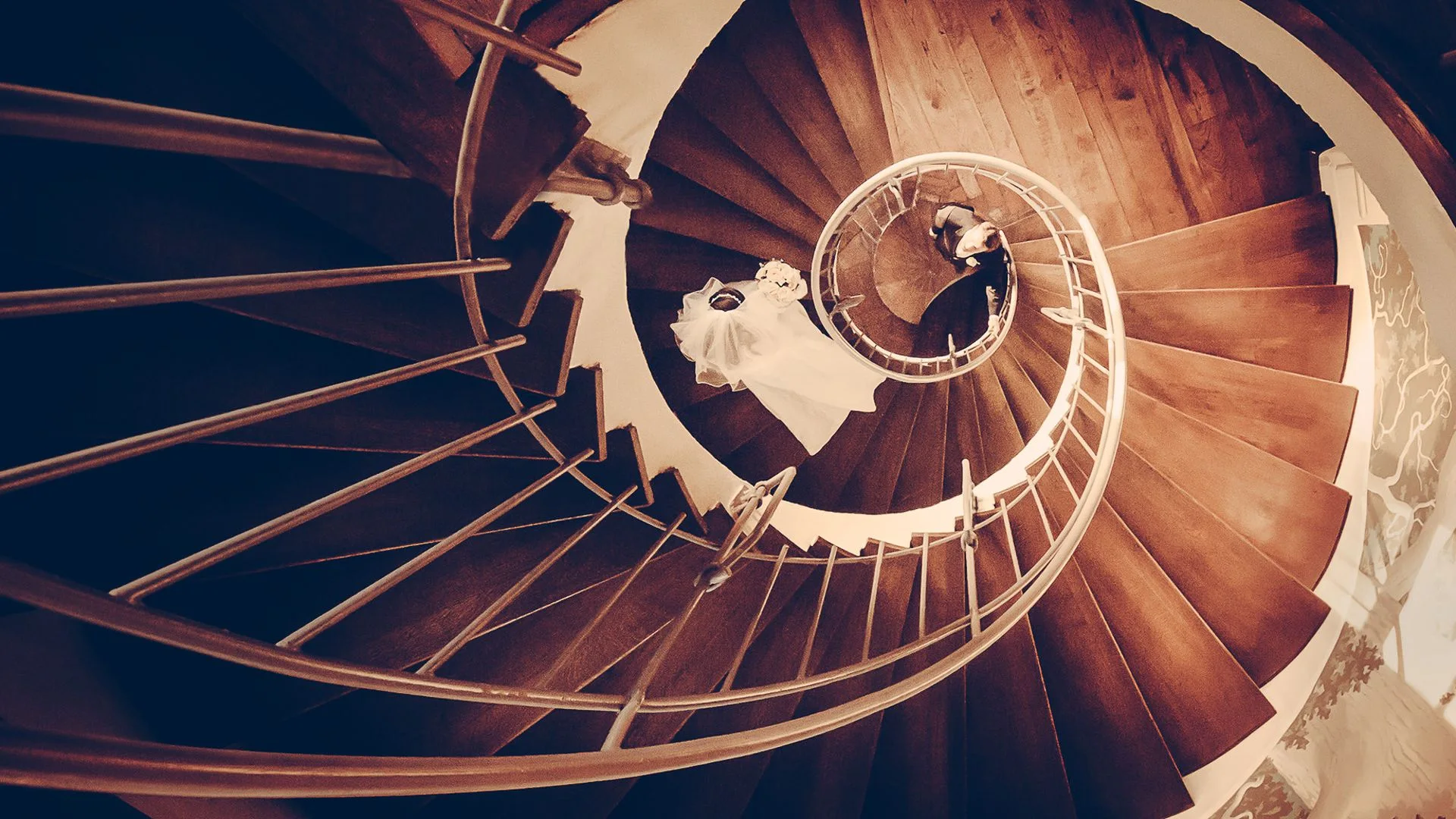 Couple seen from above on a spiral staircase — wedding photographer Germany