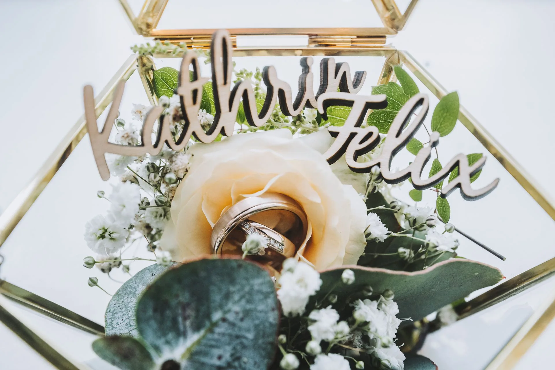 Wedding rings in a cream rose